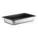 A silver Vollrath stainless steel pan with a black SteelCoat lid.