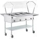 A ServIt electric commercial steam table food warmer with a clear cover on wheels.