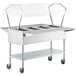 A ServIt stainless steel electric steam table on wheels with a clear cover.