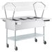 A ServIt open well electric steam table with clear sneeze guards over food pans.