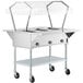 A ServIt stainless steel electric steam table on wheels with a clear cover.