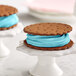 A cookie with blue frosting on top.