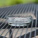 A Libbey glass ashtray on a table.