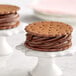 A chocolate ice cream sandwich on a white surface.