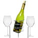 A green wine bottle and two clear wine glasses in metal stands.