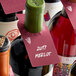 A group of wine bottles with Franmara Chalkboard Wine Tags on them.