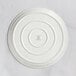 A white RAK Porcelain pizza plate with a circular design on it.