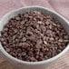 A bowl of Van Leer semi-sweet chocolate chips on a table.