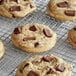 A chocolate chip cookie on a cooling rack.