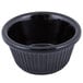 A black fluted melamine ramekin with a white background.