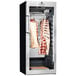 A DRY AGER UX1500 Pro meat curing cabinet with meat hanging on a rack.