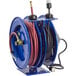 A blue Coxreels hose reel with a low pressure air hose and power cord attached.