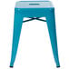 A teal metal backless stackable stool with square legs.