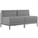 A Flash Furniture grey leather lounge bench with metal legs.