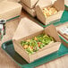 A salad in an EcoChoice Kraft PLA lined take-out box.