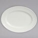 A white oval Tuxton china platter with a swirl rim design.