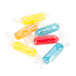 Assorted fruit rods in plastic bags with colorful wrappers.