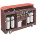 A mahogany brown Cambro portable bar cart with bottles and cylinders on it.