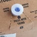 A close-up of a Jarritos Strawberry soda syrup box with a blue plastic cap.