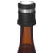 A Pulltex AntiOx Deluxe wine stopper with a carbon filter in a brown wine bottle.