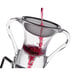A Decantus stainless steel sediment screen being used to pour red wine into a glass container.