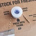 A close-up of a Pure Craft Beverages bag in box with a blue button.