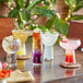 A table with Libbey Symbio martini glasses filled with drinks.