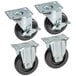 A set of four Cooking Performance Group casters with black rubber wheels.