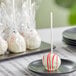 A Chalet Desserts red velvet cake pop on a stick.