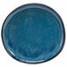 A white porcelain plate with an indigo center and specks.