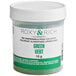 A jar of green powder with a white label.