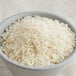 A bowl of Thai jasmine rice on a table.