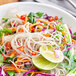 A bowl of sweet potato noodles with vegetables.