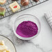 A bowl of Roxy & Rich Purple fat dispersible powder.