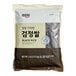 A bag of Assi black rice with black text on it.