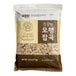 A case of Assi Twelve Grain Rice bags with brown and white text.