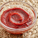 A bowl of hot pepper paste on a table.