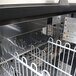 A Turbo Air stainless steel bottle cooler on a counter.