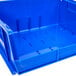 A blue plastic Metro stack bin with holes.