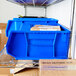 A blue Metro stack bin on a shelf with boxes inside.