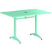 A Lancaster Table & Seating dining height outdoor table with a sea foam green top and metal legs.