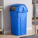 a blue trash can with a lid
