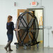 A woman pushing a Big Ass Fans Black Jack portable floor fan.