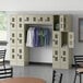 A room with a Regency beige 3 tier locker and chairs.