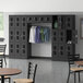A room with a Regency Black 3 Tier Locker and chairs.