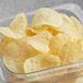 A clear container of Good's red homestyle potato chips.