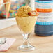 A glass of ice cream with LorAnn Caramel Flavor Fountain syrup on a counter.