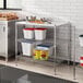 Regency metal shelving with food containers on the shelves.