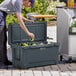 A man putting a can into a CaterGator outdoor cooler.