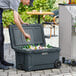 A man putting a can into a CaterGator outdoor cooler.